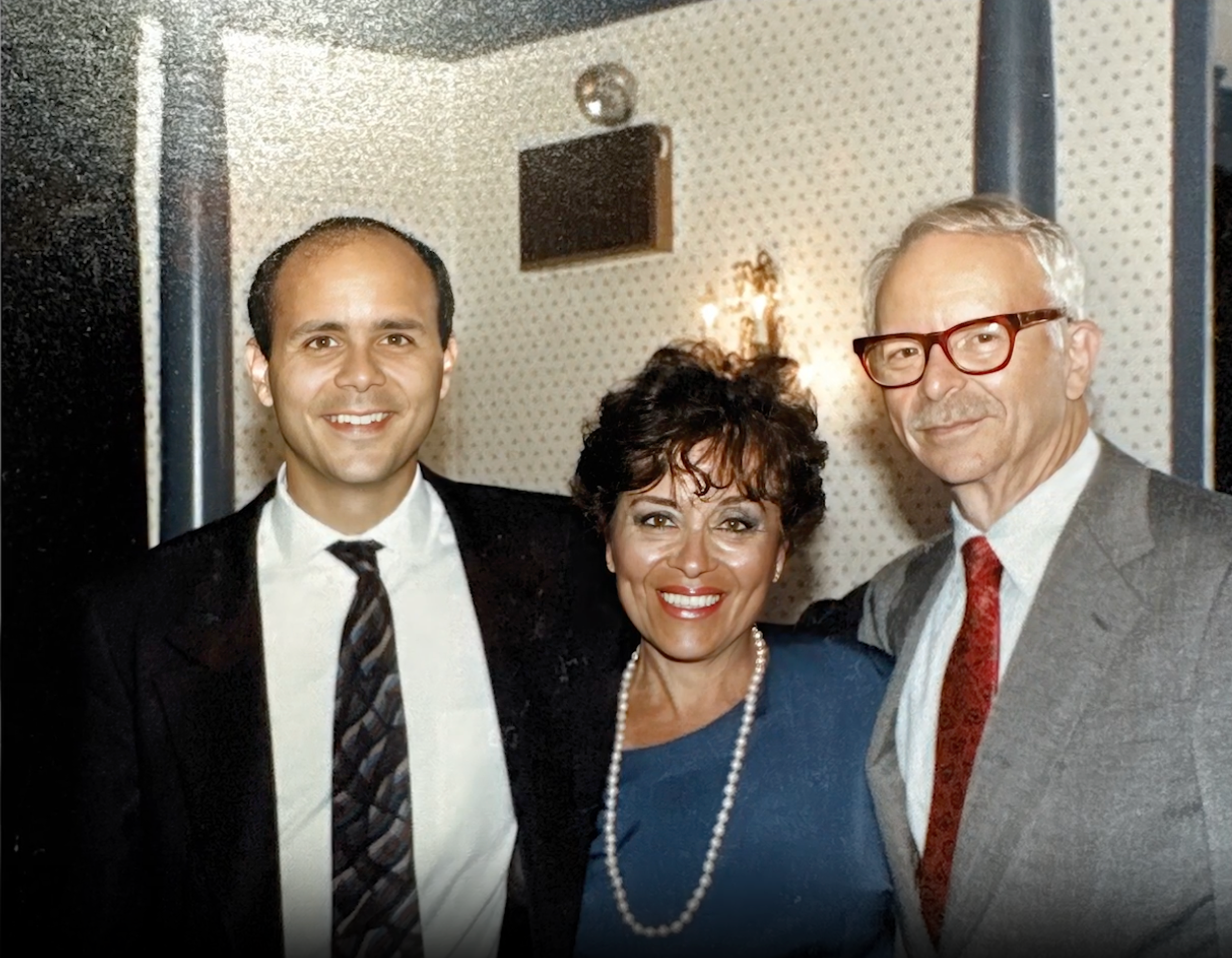 Joe Wein, his father Irving Wein, and mother Zahava Wein standing together in a photo.